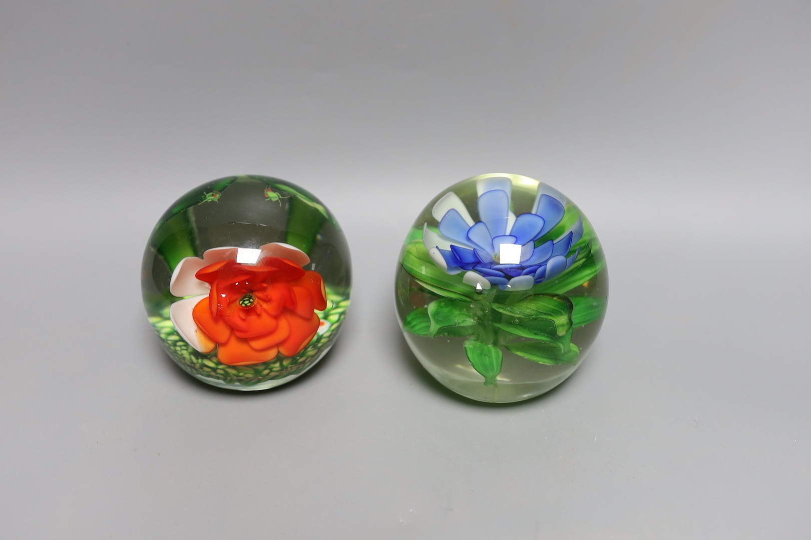 A collection of nine glass paperweights including Victorian dumps and millefiori